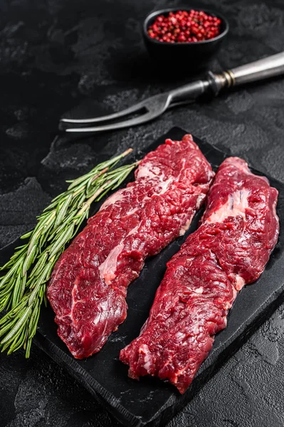 Raw Machete steak or hanging tender cut with herbs. Black background. Top view — Stock Photo, Image