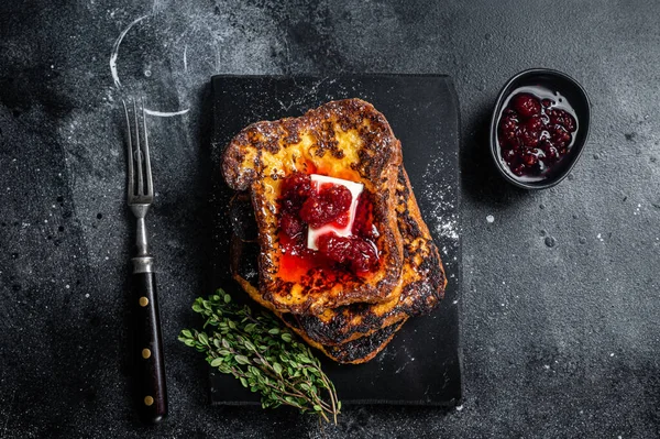 Raspberry French Toast with butter on marble board. Black background. Top view — стоковое фото