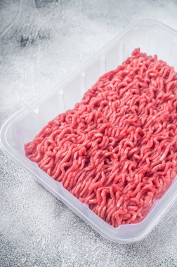 Elektrik süpürgesinde taze çiğ kıyma ve domuz eti. Beyaz arka plan. Üst görünüm