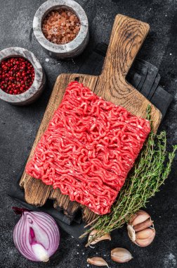 Çiğ kıyma, kıyma dilimlenmiş et. Siyah arka plan. Üst görünüm
