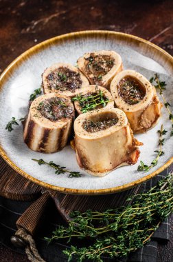 Kekik ve otlarla pişirilmiş kemik iliği eti. Karanlık arka plan. Üst görünüm