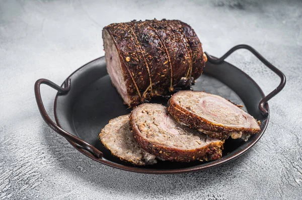 Sliced roast pork meat roulade on a steel tray. White background. Top view — Stock Photo, Image