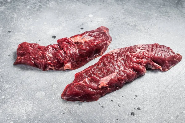 Machete steak raw cut or hanging tender cut. Gray background. Top view.