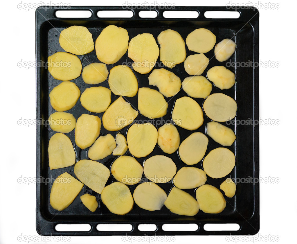 Sliced potato slices on a baking sheet