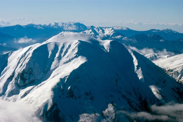 Mountain top covered in snow, aerial view Stock Photo