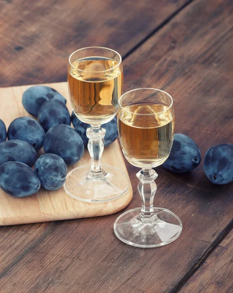 Acquavite di prugne o grappa con prugne fresche e gustose — Foto Stock