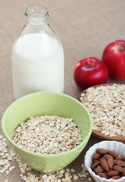 Bowl of oatmeal with apples almonds and milk — Stock Photo, Image