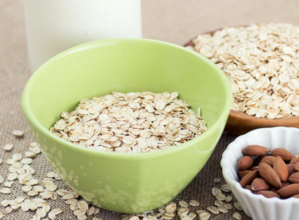 Bowl of oatmeal with almonds and milk — Stock Photo, Image