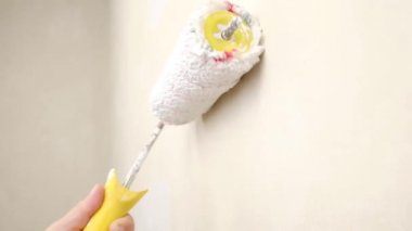 paint the wall with a white roller. High quality FullHD footage