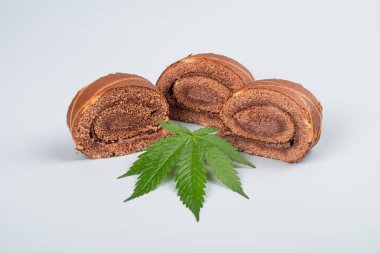 sweet biscuit roll with thc and green cannabis leaf.