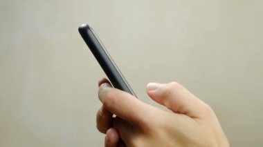 femele typing a message on a black phone closeup. High quality FullHD footage