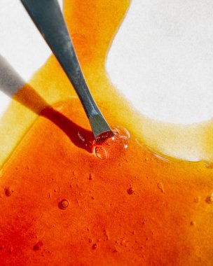 cannabis golden extract oil, metal stick and wax high thc.