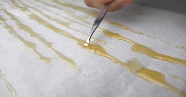 Golden Dabs Cannabis Extract Resin Smoking Scraper Parchment Paper High — Stock video