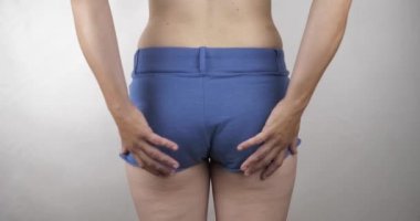 extra weight on female buttocks, woman shaking her buttocks with her hands High quality 4k footage