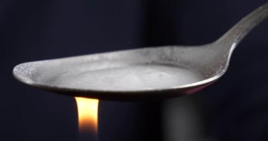 cooking with a lighter a narcotic substance on a spoon, boiling crystal drugs High quality 4k footage