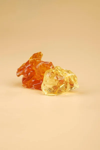 amber yellow pieces of cannabis wax closeup