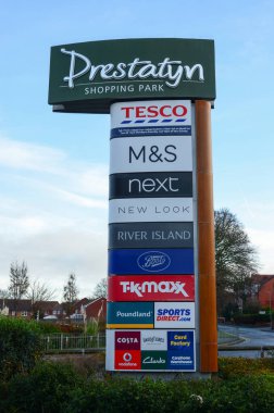 Prestatyn, UK: Dec 14, 2021:A sign at the Nant Hall Road entrance lists the shops which are on Prestatyn Shopping Park. clipart