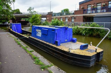 Chester, UK: Jul 3, 2022: A narrowboat barge which is used for canal maintenance is seen here moored on the Shropshire Union Canal in Chester