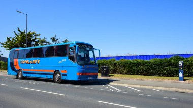 Rhyl, UK: Aug 11, 2022: A coach operated by Copeland's Tours is parked in a coach parking bay in the Welsh seaside resort of Rhyl