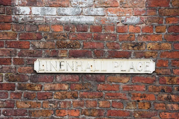 Faded Street Name Sign Linenhall Place Mounted Red Brick Wall — Stock fotografie