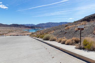 View of low water level at Lake Mead, Nevada in 2022 with sign showing where it was in 2002.