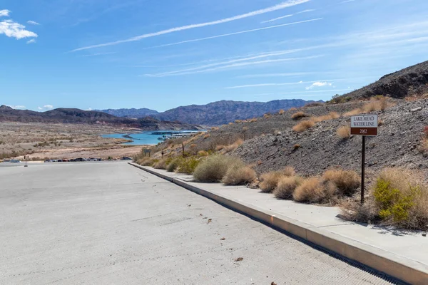 View of low water level at Lake Mead, Nevada in 2022 with sign showing where it was in 2002.
