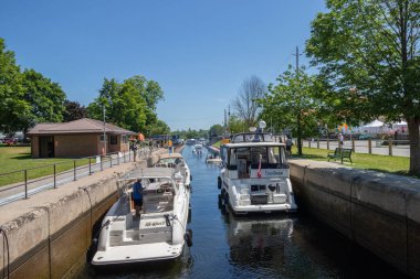 Bobcaygeon, Ontario, Canada - June 25, 2022: Pleasure craft travelling through Lock 32 on the historic Trent Severn Waterway. The canal is managed by Parks Canada and is a popular tourist attraction in the summer.