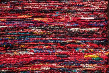 close up of a colourful red striped rug background