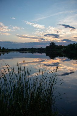 cloudy sunset over a calm lake