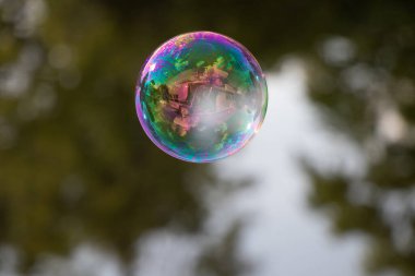 a soap bubble reflecting a boat