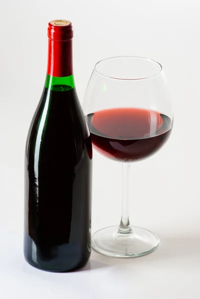 Wine bottle and a glass filled with wine isolated on white — Stock Photo, Image