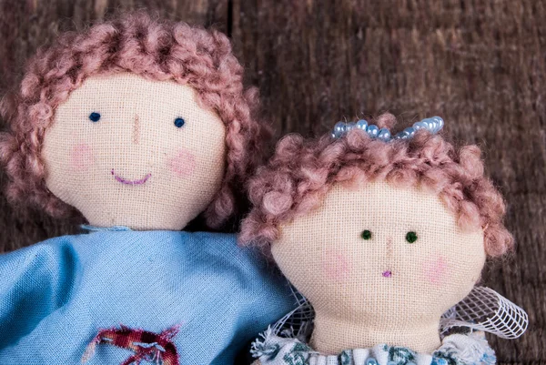 couple of dolls on wood