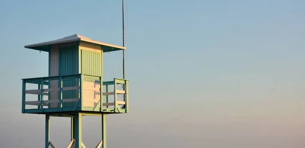 stock image View of the lifeguard observation tower from the beach at sunset