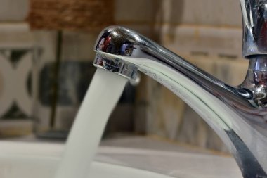 Detail of a stream of water falling from a tap