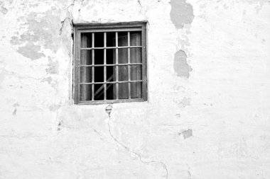 Different windows in old facades of a medieval town, in black and white