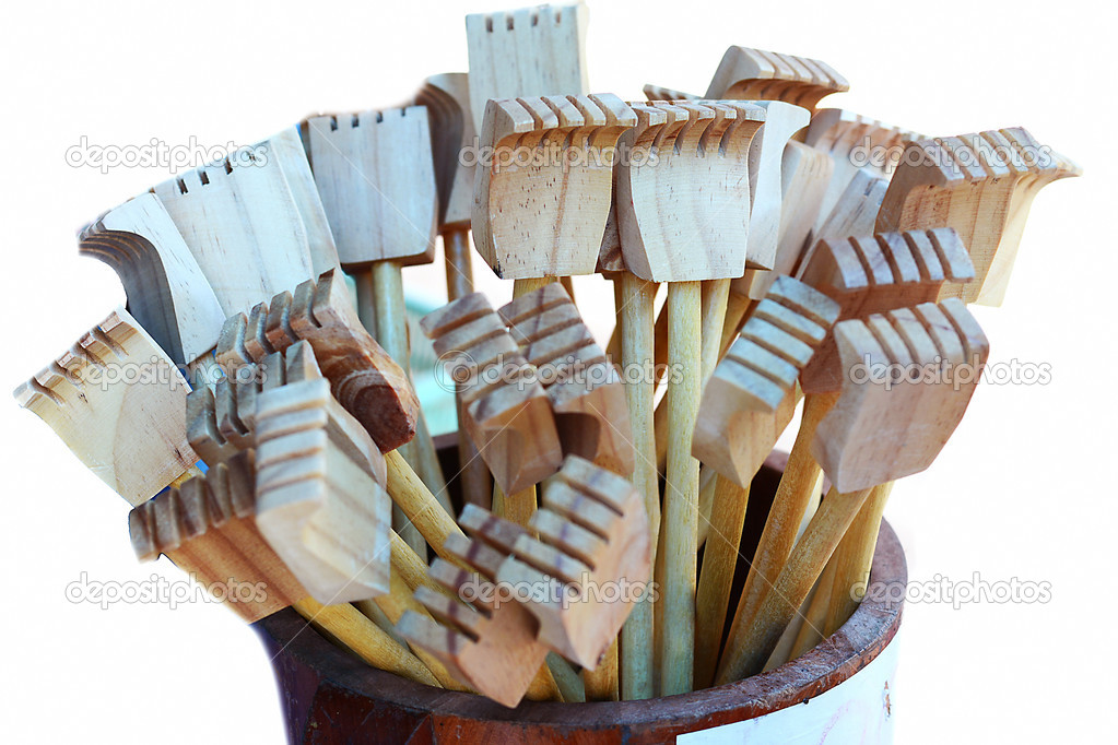 a wooden backscratcher on a white background.