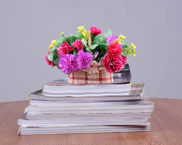 Flower vase on book — Stock Photo, Image