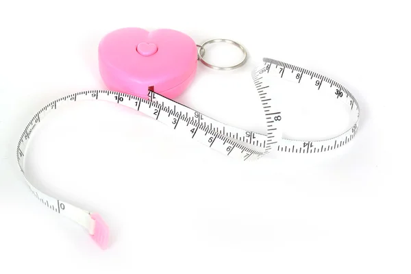 Measuring tape in heart roll — Stock Photo, Image