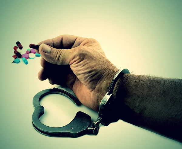 Handcuffed Man Holding Medicine — Stock Photo, Image