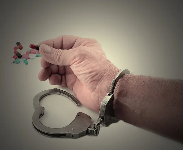 Handcuffed Man Holding Medicine — Stock Photo, Image