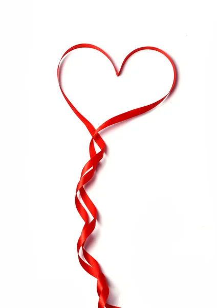 Red ribbon in heart shape — Stock Photo, Image