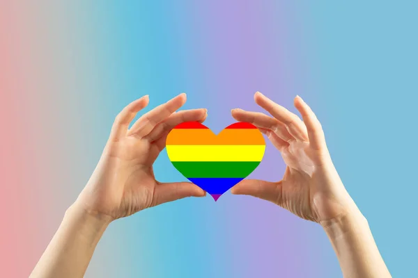 Female Hands Hold Rainbow Heart Blue Background — Stock Photo, Image
