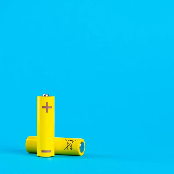 Two Yellow Alkaline Batteries Nimh Rechargeable Batteries Blue Background Space — ストック写真