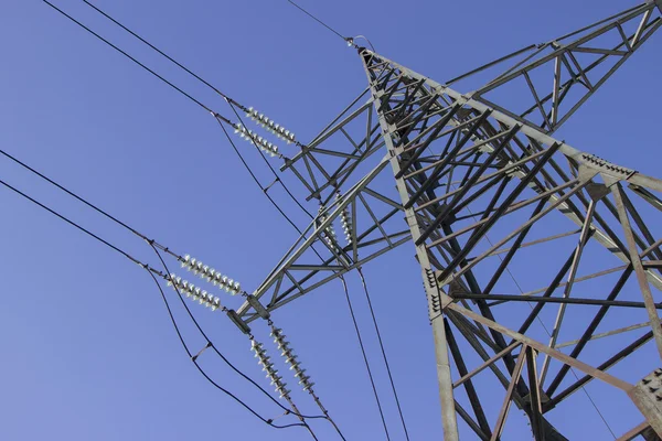 High voltage transmission pylon on blue sky background — Stock Photo, Image