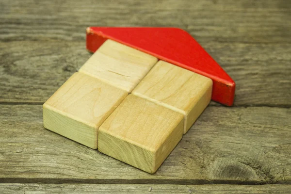 Wooden blocks house on wooden background