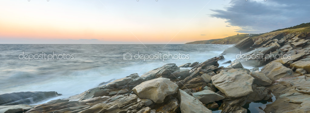 Panorama of ocean shore at a crack of dawn (Slow shutter speed)