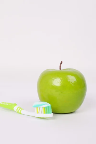 Toothbrush with toothpaste and apple — Stock Photo, Image