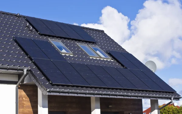 Özel evin çatısındaki modern güneş panelleri. Emlak konsepti için yenilenebilir enerji