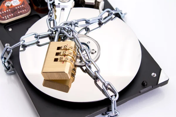 Hard drive disk and combination lock padlock. — Stock Photo, Image