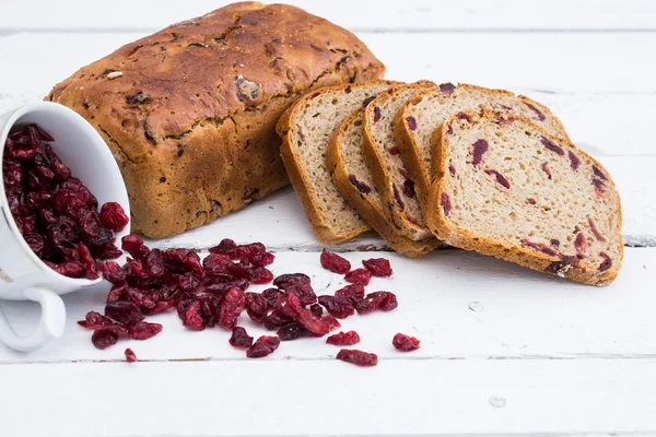 Bread with cranberries on white wooden board — Stock Photo, Image